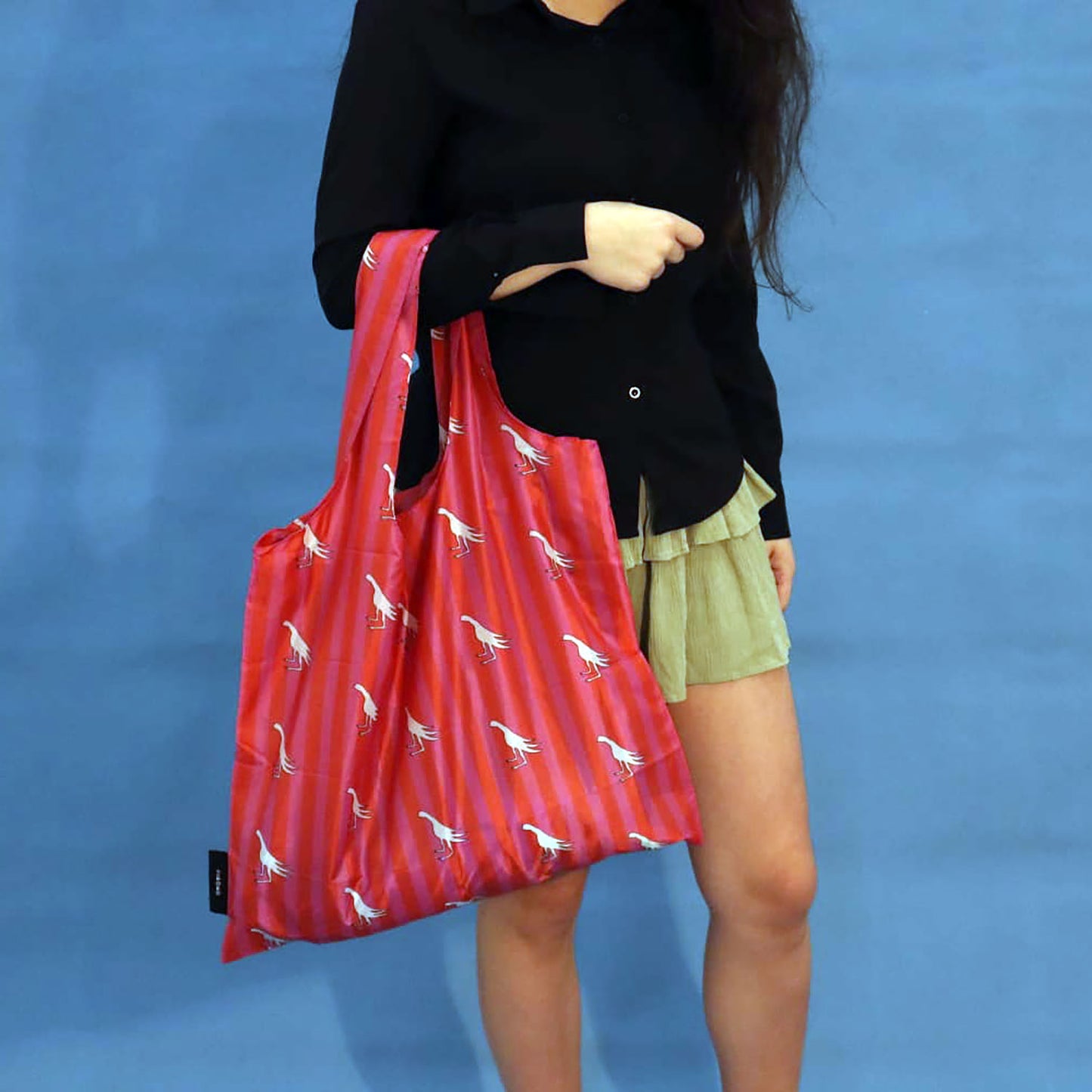 Person carrying a pink Fiery Pheasant tote bag