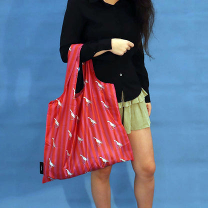 Person carrying a pink Fiery Pheasant tote bag