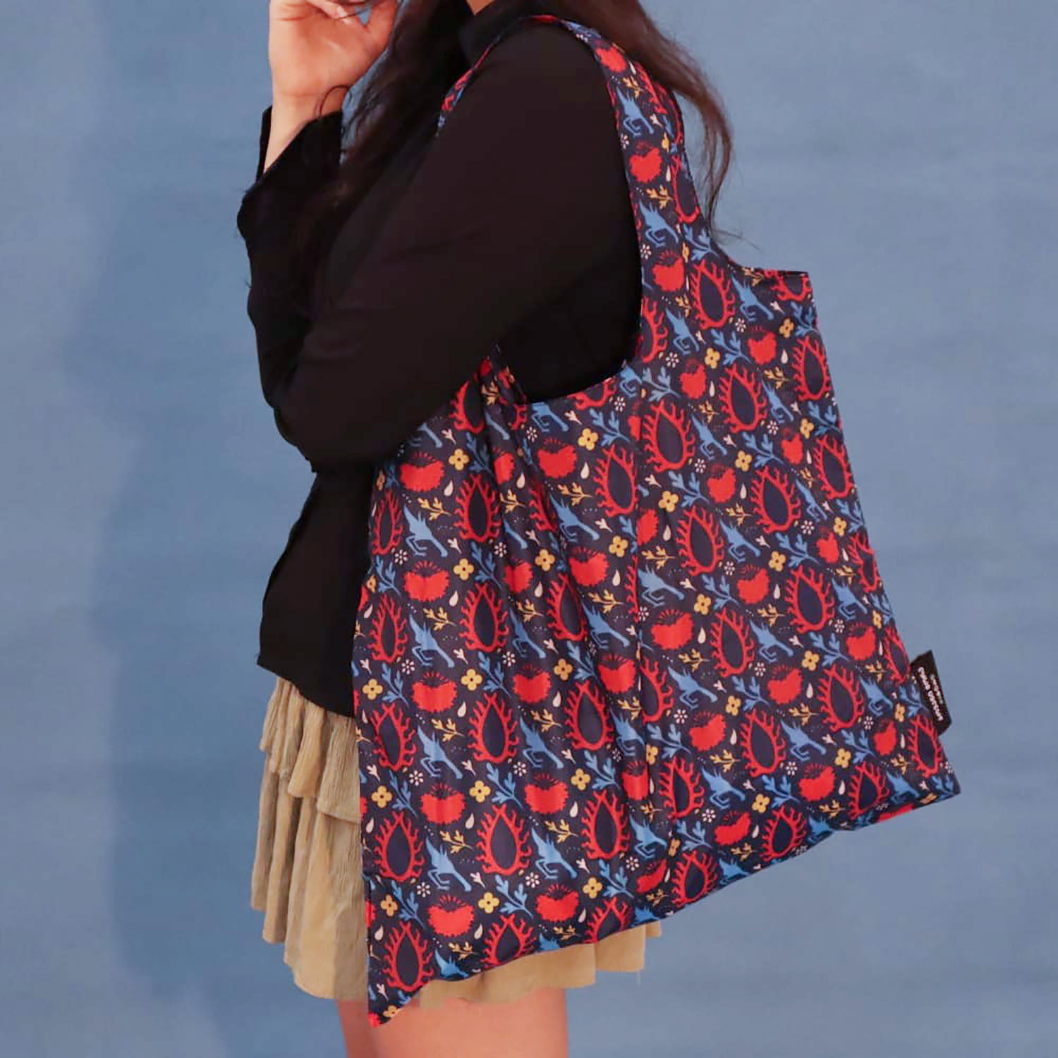Blue Eye of the Sun tote bag worn over the shoulder