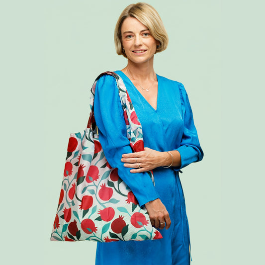 Person carrying a white Pomegranates tote bag