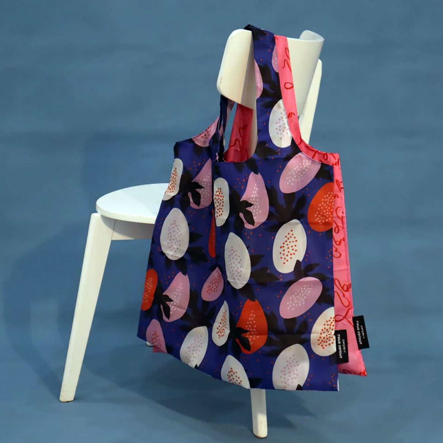 Blue Papaya tote bag displayed on a chair