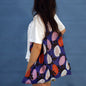 Person carrying a blue Papaya tote bag