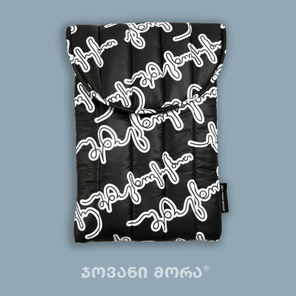 Black polyester laptop sleeve with Live Your Own Life Georgian lettering print by Giovanni Morra