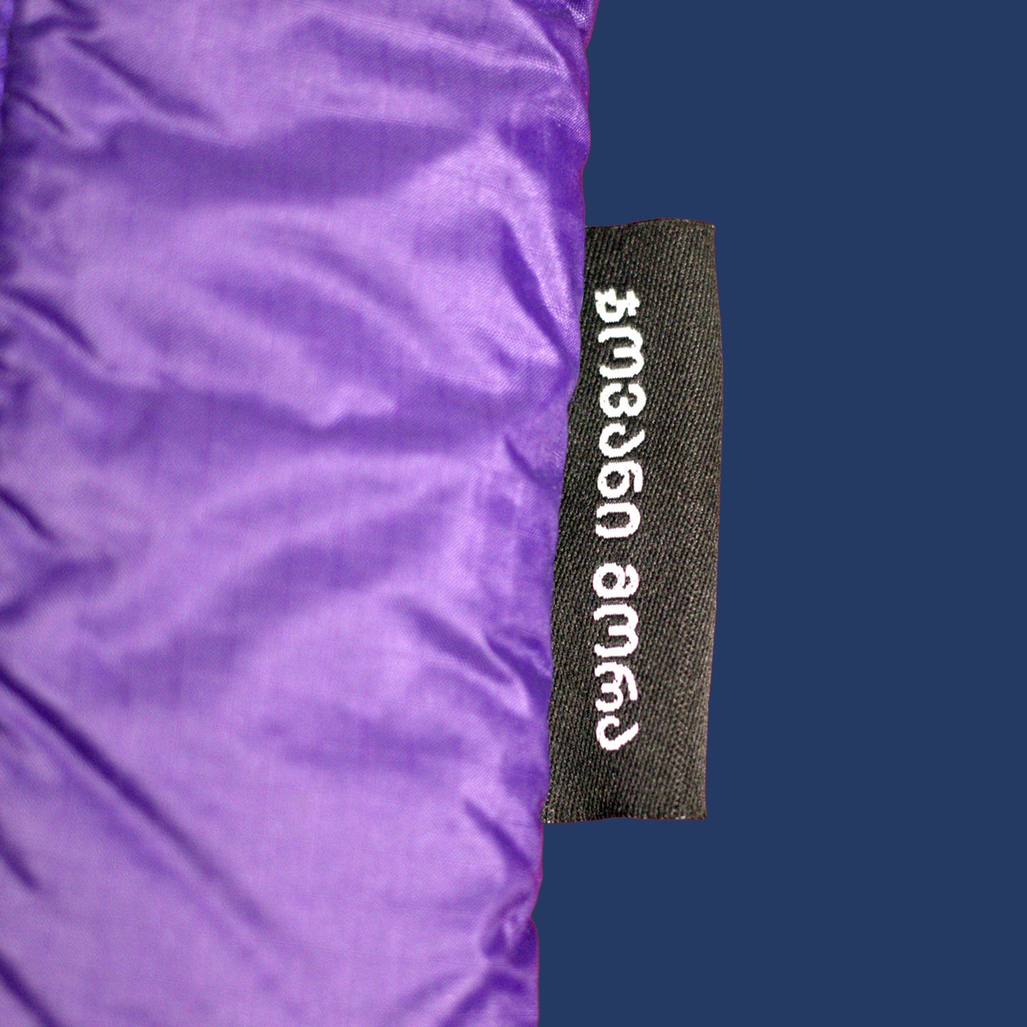 Close-up of Giovanni Morra label on indigo dark-violet padded laptop sleeve