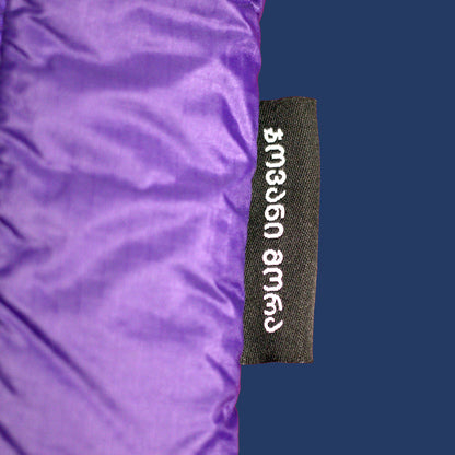 Close-up of Giovanni Morra label on indigo dark-violet padded laptop sleeve