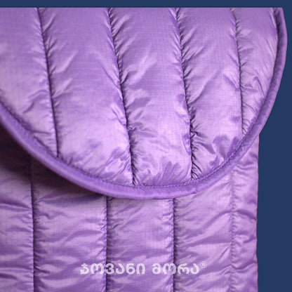 Close-up of quilted stitching and padded texture on indigo dark-violet polyester laptop sleeve