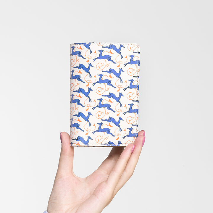 Beige Deer’s Leap vegan leather passport holder held in hand