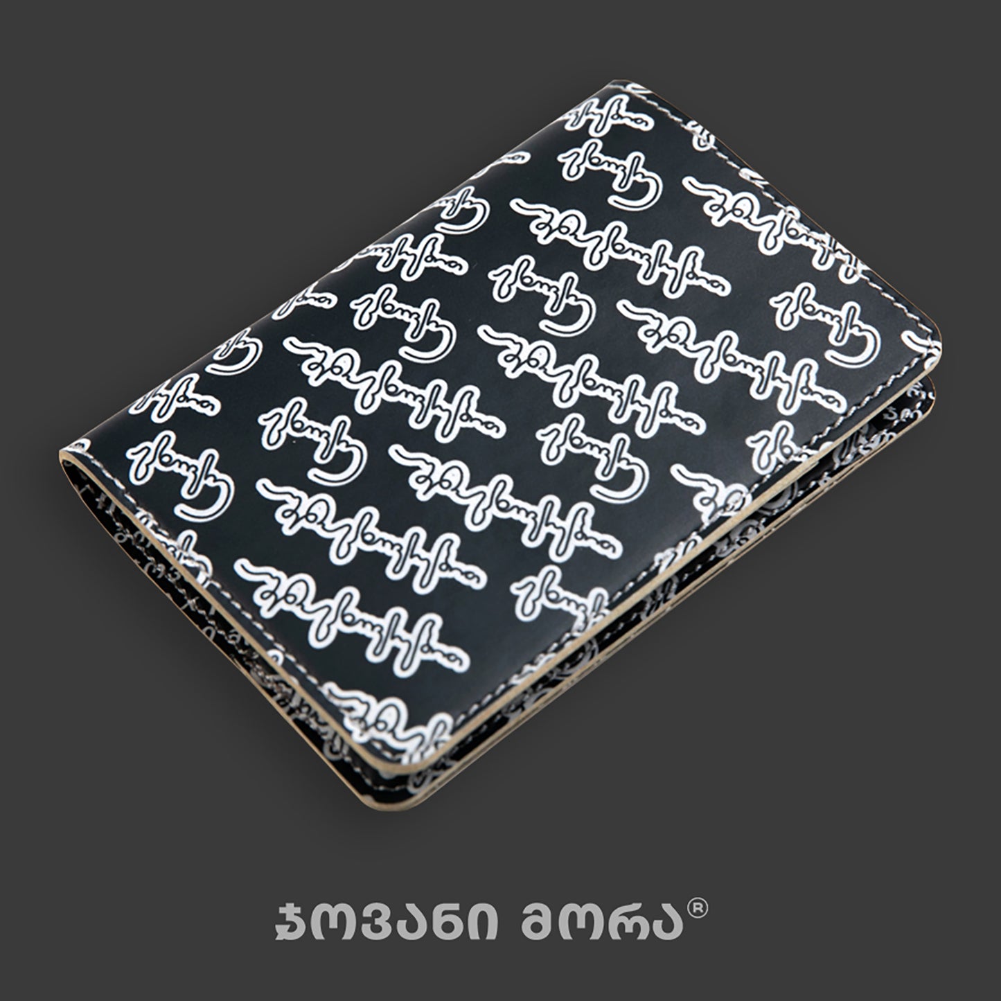 Folded black and white vegan leather passport holder with Live Your Own Life print by Giovanni Morra