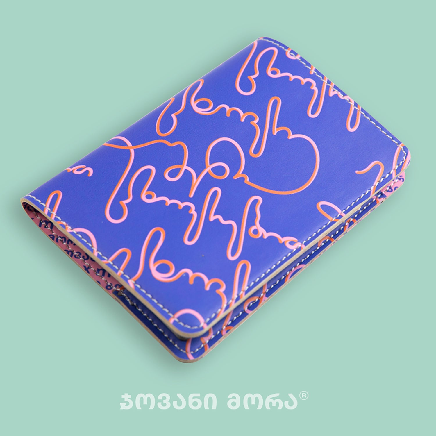 Angled view of folded purple and pink Live Your Own Life passport holder