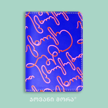 View of folded purple and pink Live Your Own Life passport holder