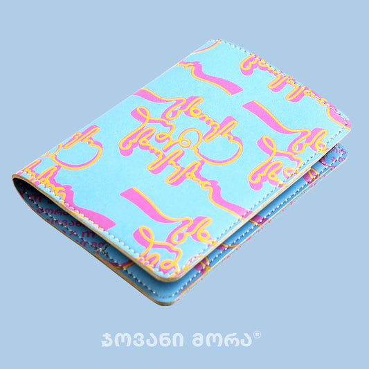 Folded sky blue and yellow vegan leather passport holder with Live Your Own Life print by Giovanni Morra