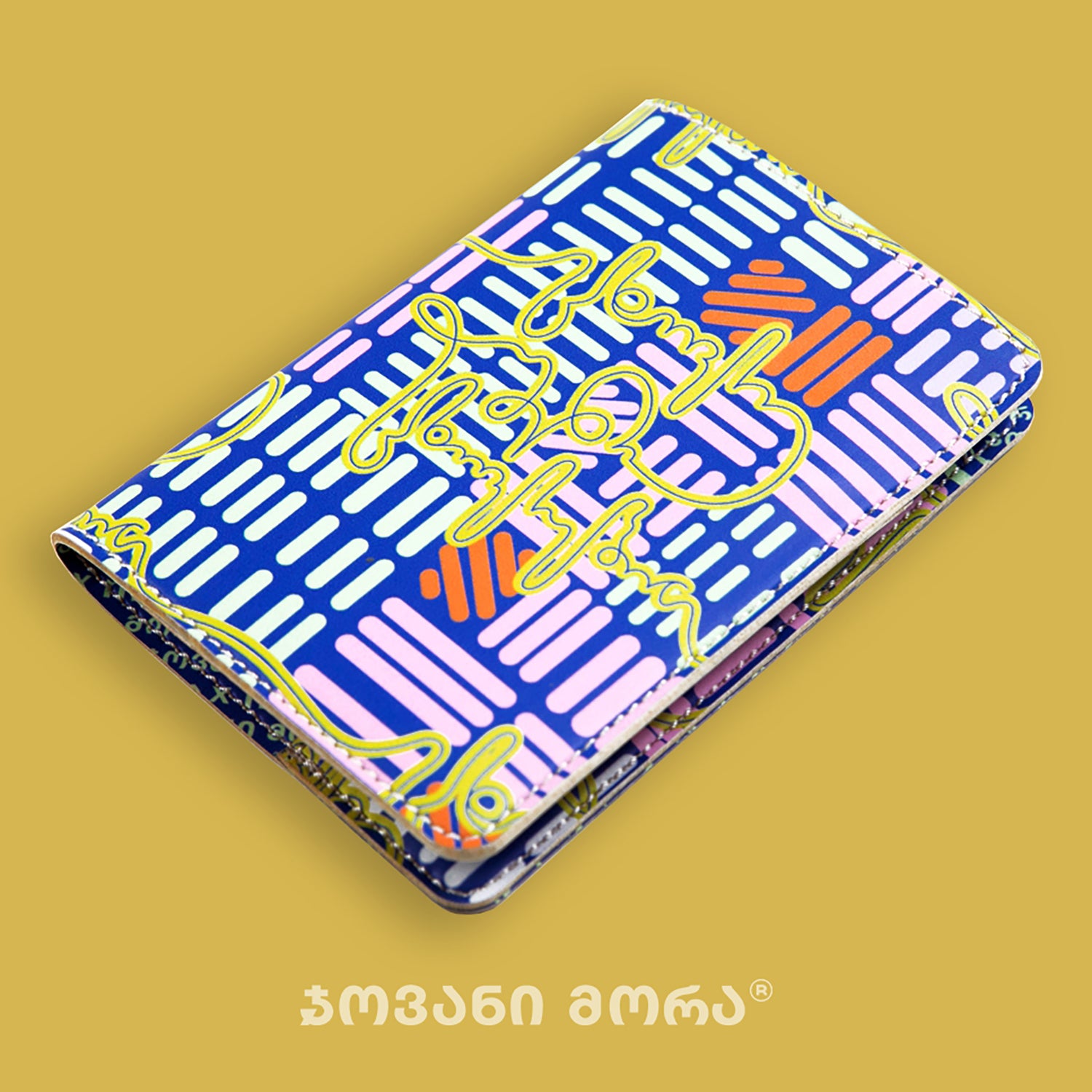 Folded multicolor and yellow vegan leather passport holder with Live Your Own Life print by Giovanni Morra