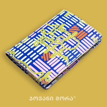 Folded multicolor and yellow vegan leather passport holder with Live Your Own Life print by Giovanni Morra
