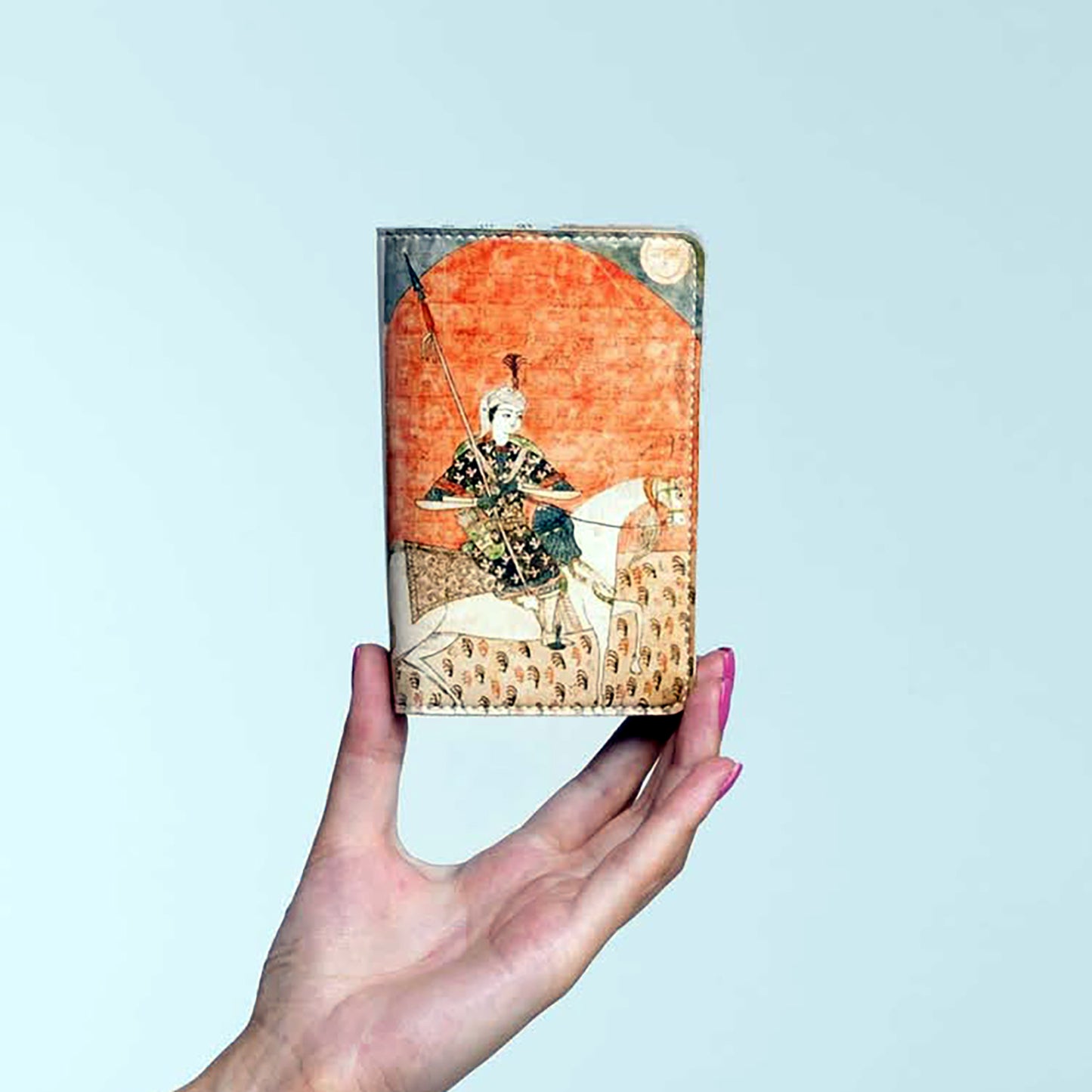 Folded beige Avtandili passport holder held in hand