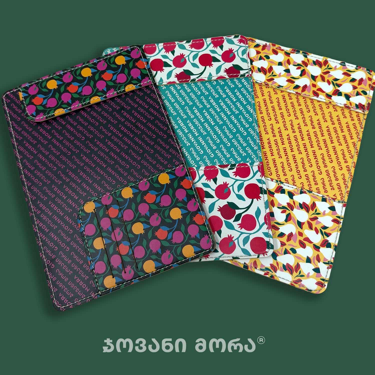 Four colorful patterned passport holders arranged in an overlapping fan shape on a dark green background. The items feature various prints including pink and yellow fruit on green, teal text patterns, yellow text patterns, and red fruit on white.