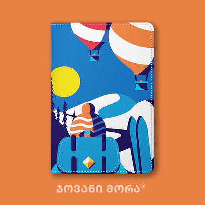 Folded blue vegan leather passport holder with Skier illustration by Giovanni Morra
