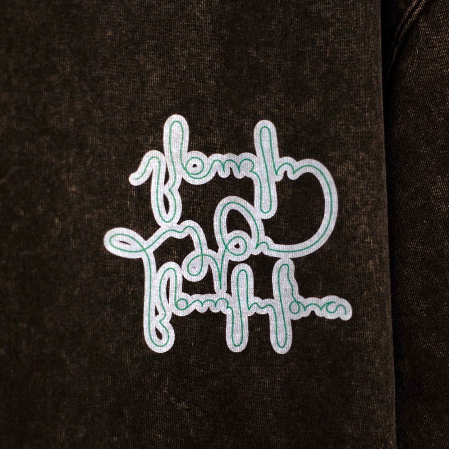Close-up of a sky-blue graphic printed on black acid-washed cotton
