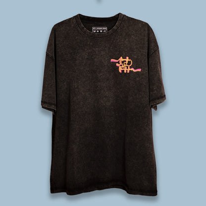 Black acid-washed T-shirt with an orange graphic displayed flat