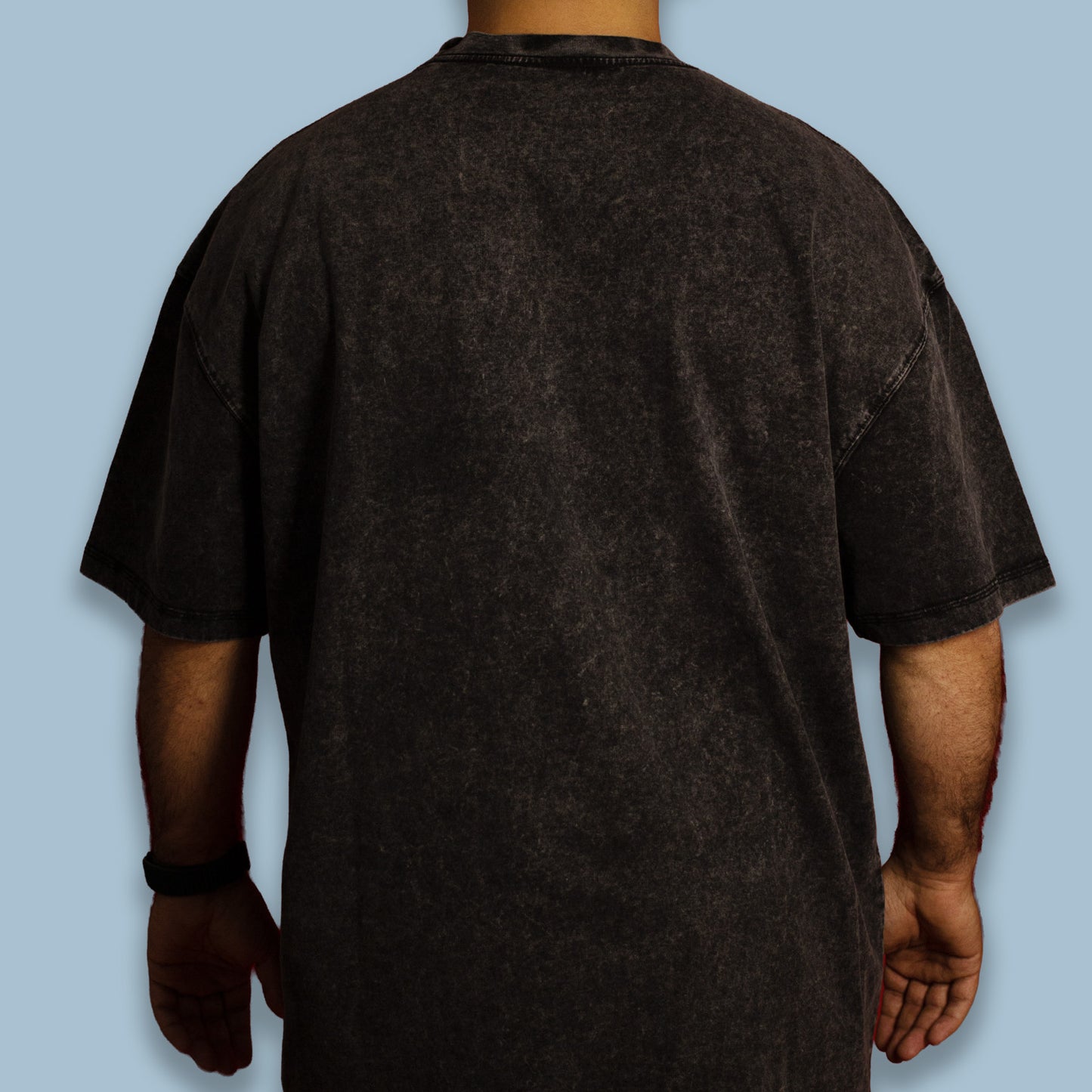 Back view of a black acid-washed oversized T-shirt