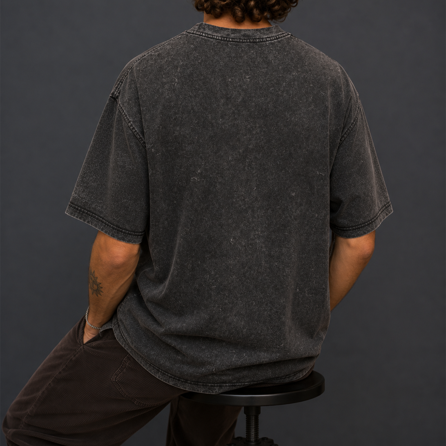 Back view of a black acid-washed oversized T-shirt