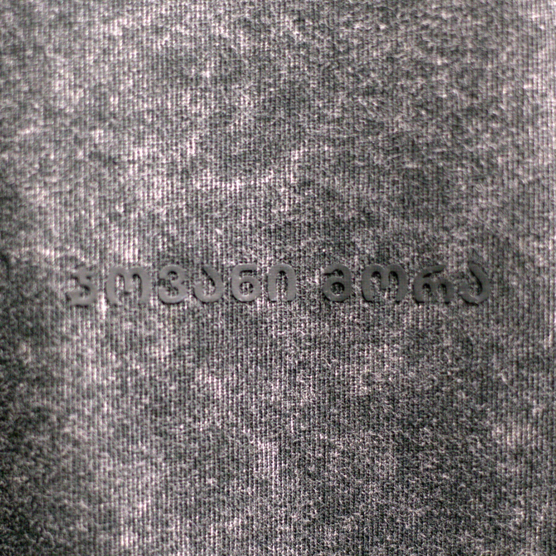 Close-up of textured black acid-washed cotton fabric