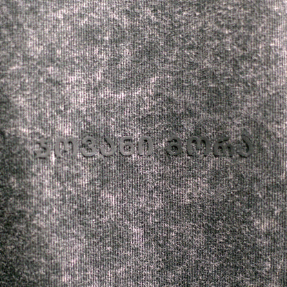 Close-up of textured black acid-washed cotton fabric