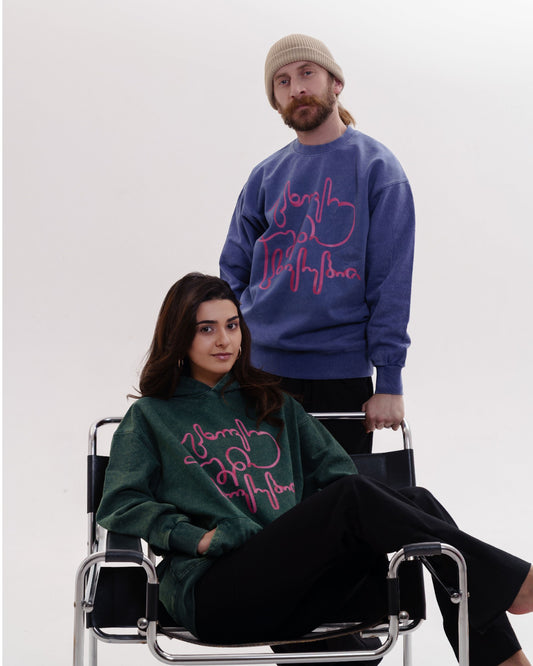 Giovanni Morra x m2 collaboration hoodie featuring the "Live Your Own Life" manifesto in minimalist typography.